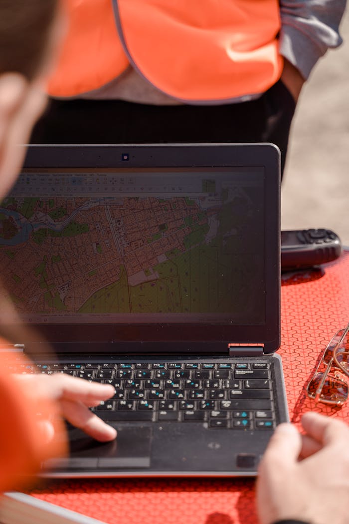 why-choose-us A field surveyor uses a laptop for mapping and navigation outdoors, ensuring accuracy.