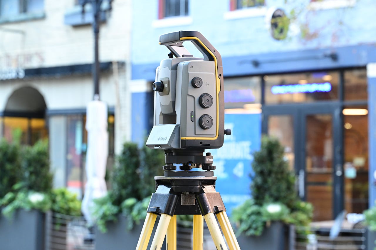 home-hero Sophisticated surveying equipment on city street showcasing modern urban mapping technology.